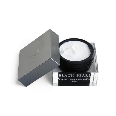 Black Pearl Perfect Day Cream 45+ with SPF25 in a black jar, partially open, revealing the white cream inside.